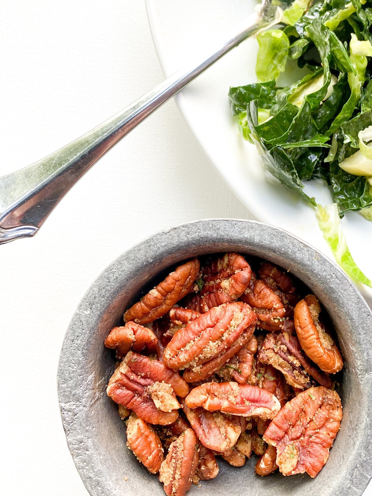 Golden brown spiced pecans in a bowl, perfectly seasoned with spices and ready for serving