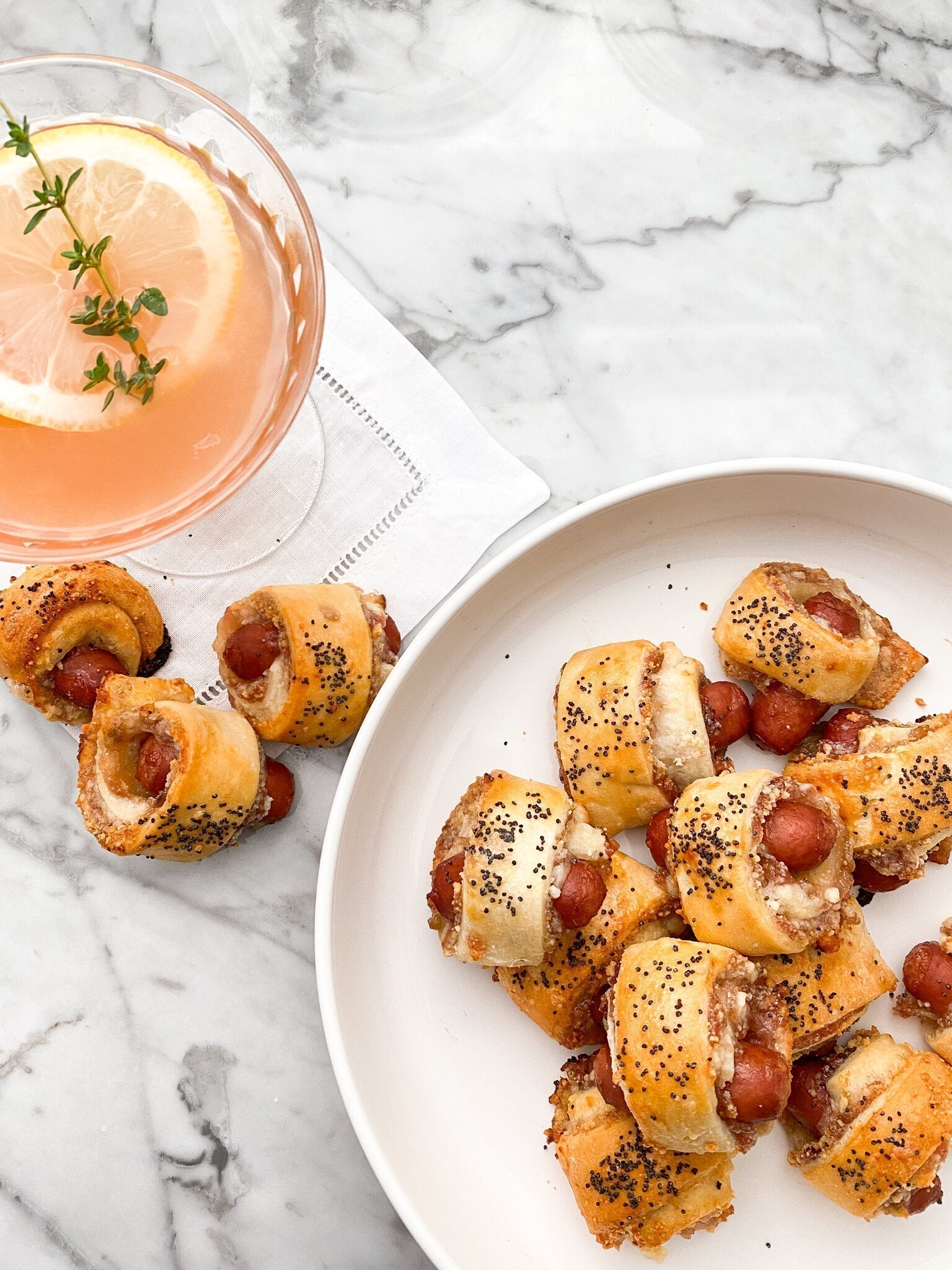 Golden brown Figgy Piggies in a Blanket appetizers with fig jam and parmesan cheese on a serving platter
