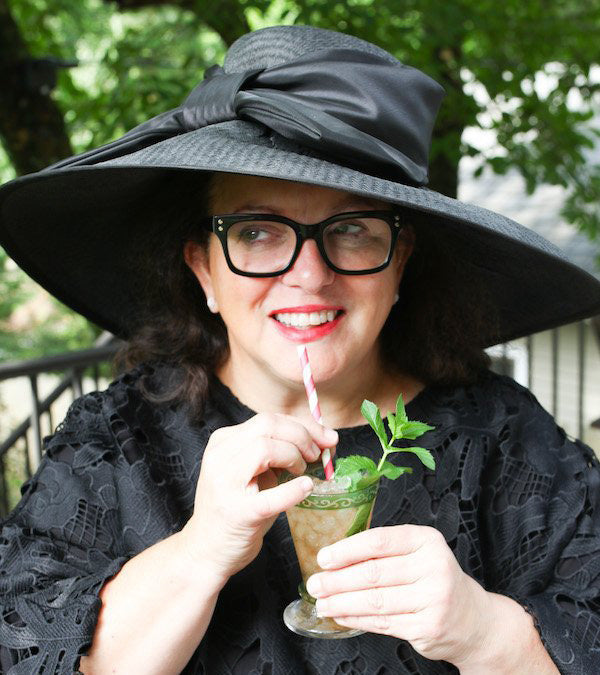 Woman wearing elaborate Kentucky Derby hat at Churchill Downs