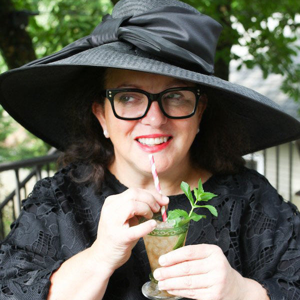 Woman wearing elaborate Kentucky Derby hat at Churchill Downs