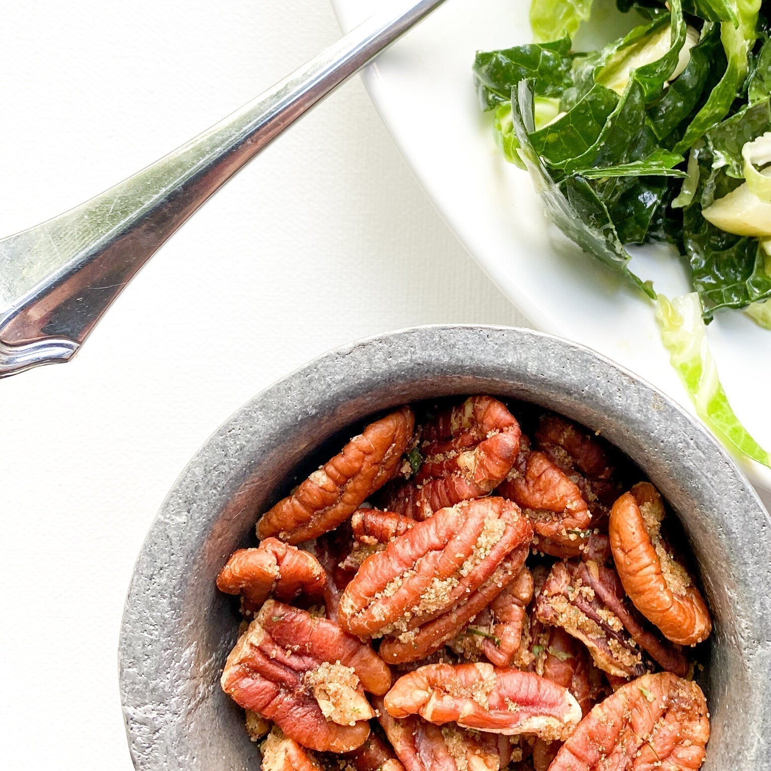 Golden brown spiced pecans in a bowl, perfectly seasoned with spices and ready for serving