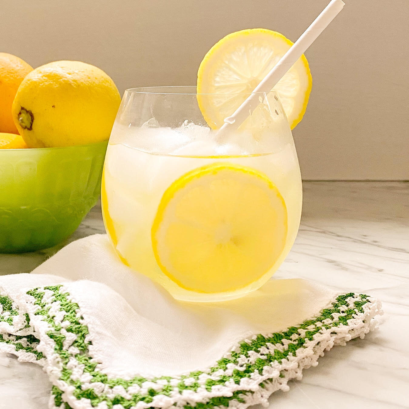 Limoncello vodka cocktail in a glass with ice and lemon slices, perfect for summer porch entertaining