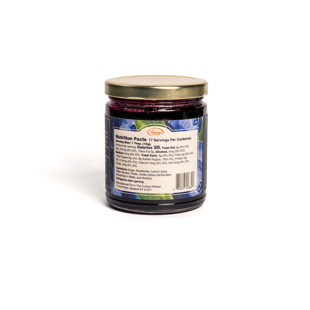 Jar of blueberry jam with a label on a white background