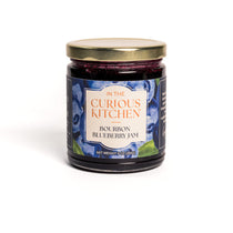 Jar of Bourbon Blueberry Jam from 'In the Curious Kitchen' on a white background