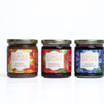 Three jars of Curious Kitchen jams on a white background