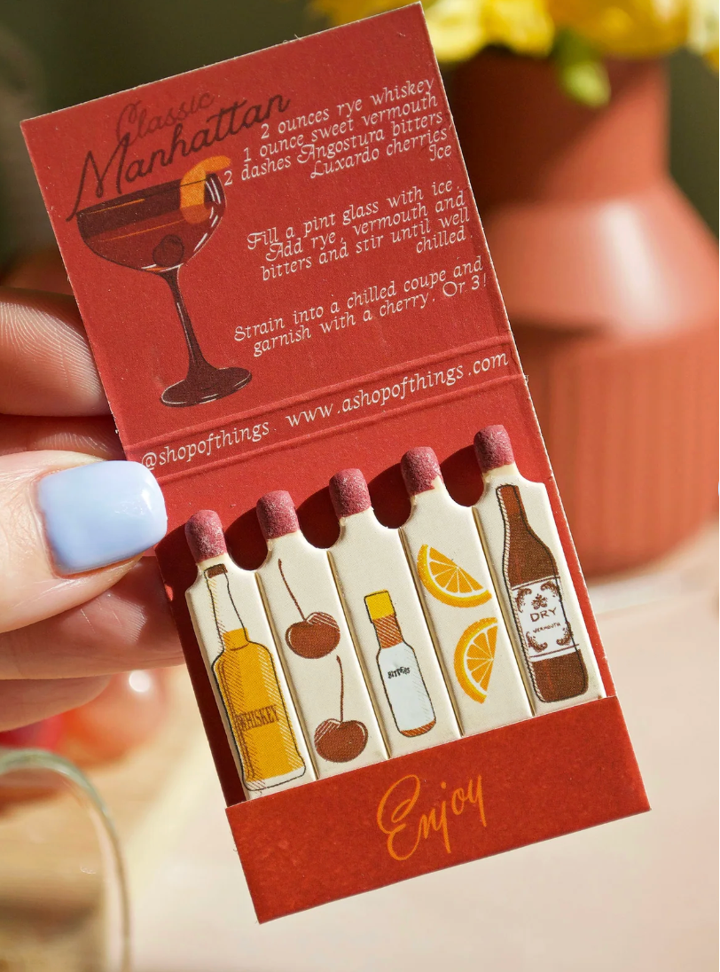 Pack of mini bottles with cocktail illustrations and text on a red background