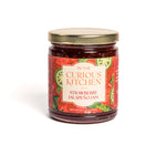 Jar of strawberry jalapeño jam from In the Curious Kitchen on a white background